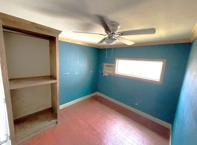 unfurnished bedroom featuring hardwood / wood-style flooring, ceiling fan, a wall unit AC, and crown molding