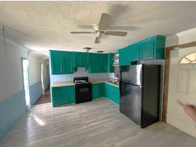 kitchen with light hardwood / wood-style flooring, a textured ceiling, black appliances, crown molding, and sink