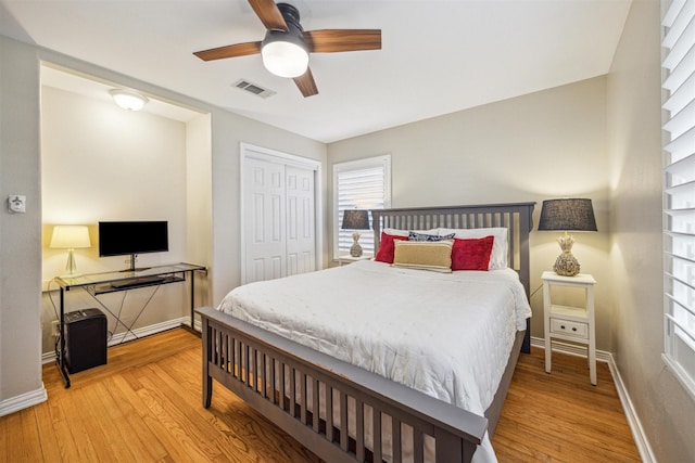 bedroom with light hardwood / wood-style flooring, a closet, and ceiling fan