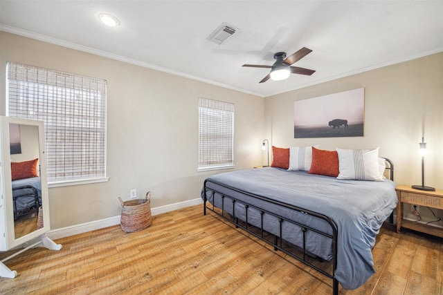 bedroom featuring ornamental molding, ceiling fan, and light hardwood / wood-style floors