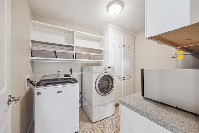 laundry room featuring cabinets and washer and dryer