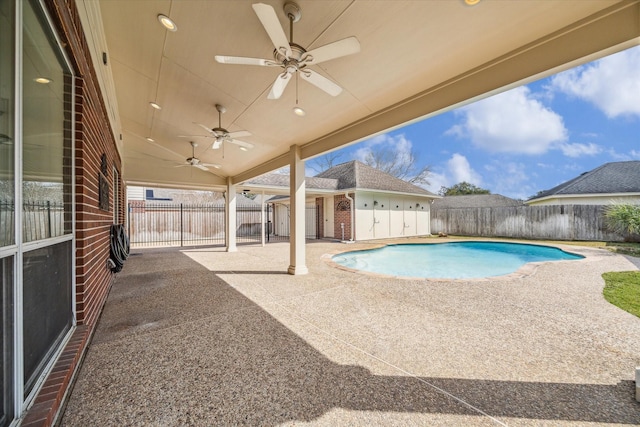 view of pool with a patio, an outbuilding, and ceiling fan