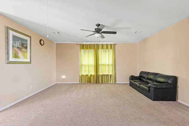 unfurnished room with ceiling fan and carpet