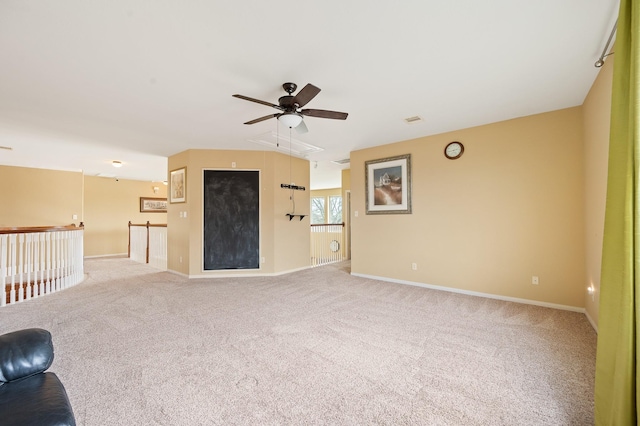 unfurnished living room featuring light colored carpet and ceiling fan