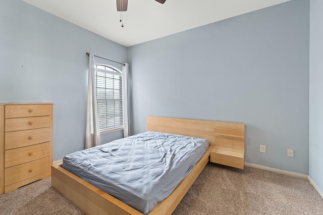 bedroom featuring light carpet and ceiling fan