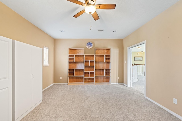 unfurnished bedroom featuring light carpet and ceiling fan