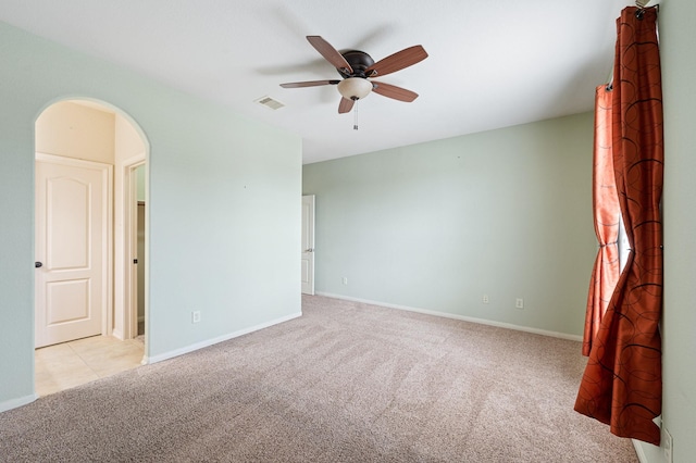 empty room with light colored carpet and ceiling fan