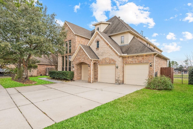 view of front of house with a garage and a front lawn