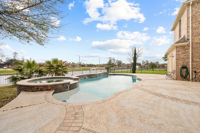 view of swimming pool with a patio area, a water view, and an in ground hot tub