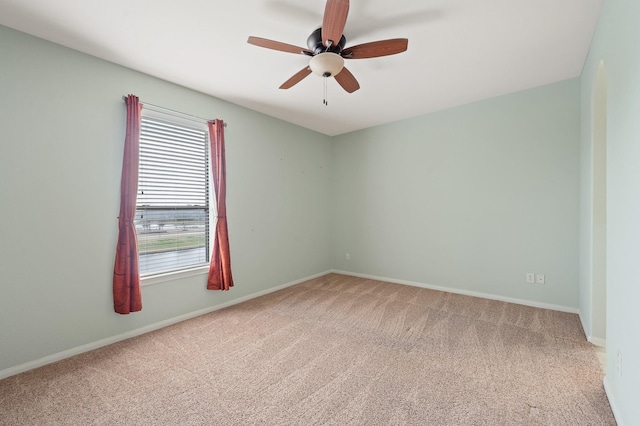 carpeted empty room featuring ceiling fan