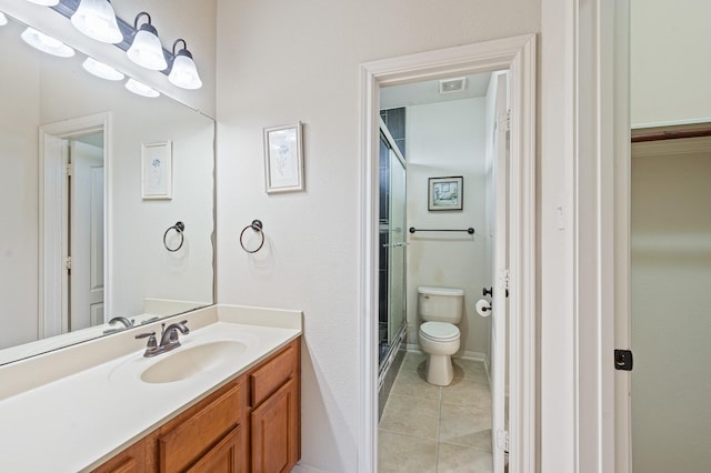 bathroom with vanity, toilet, tile patterned flooring, and a shower with door