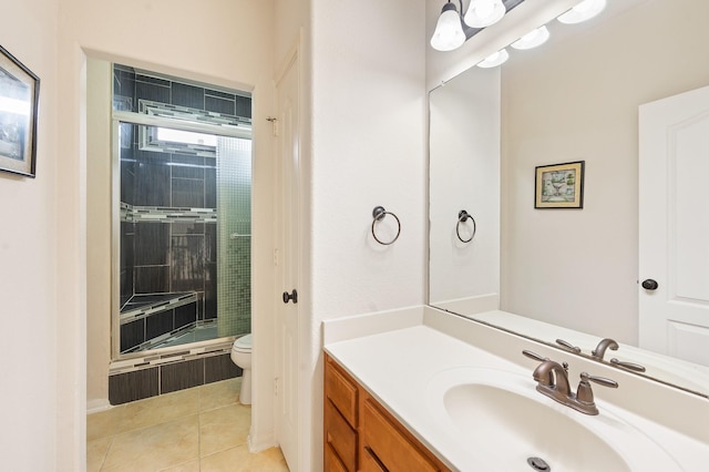 bathroom featuring tile patterned floors, vanity, toilet, and a shower with door