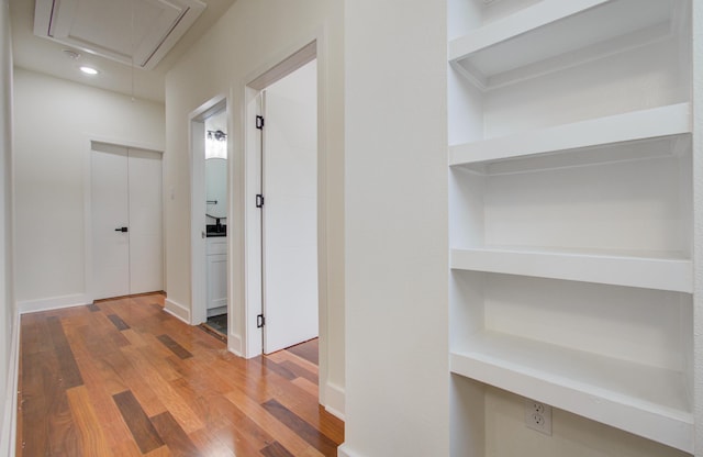 hall with hardwood / wood-style flooring