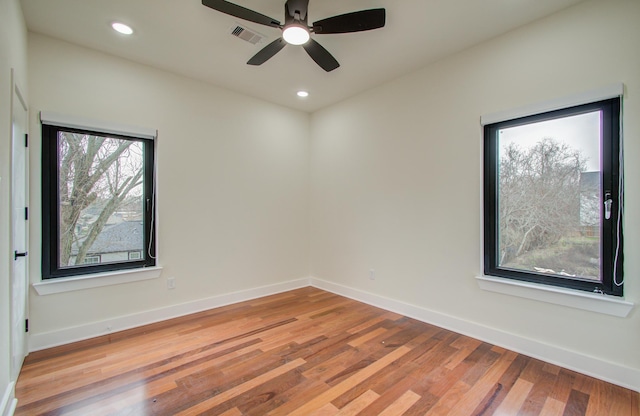 unfurnished room with hardwood / wood-style floors and ceiling fan