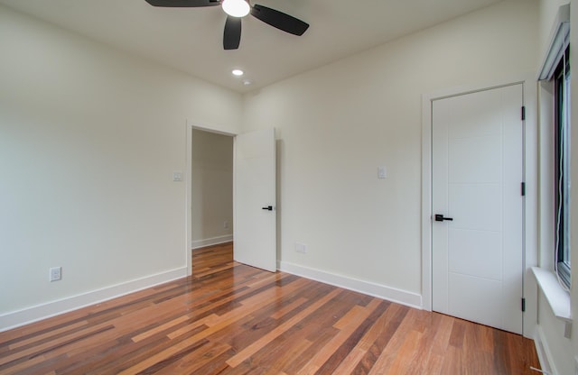 unfurnished bedroom featuring dark hardwood / wood-style floors and ceiling fan