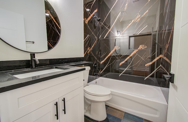 full bathroom with vanity, tiled shower / bath combo, and toilet