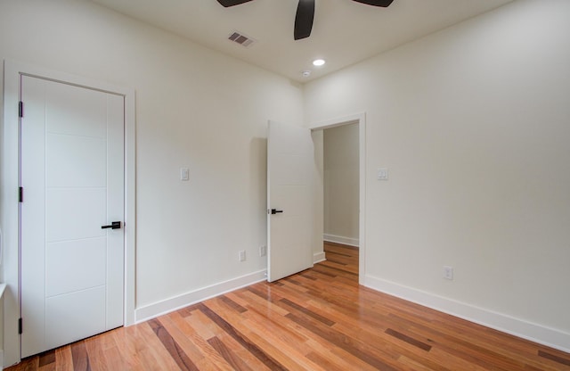 empty room with light hardwood / wood-style flooring and ceiling fan