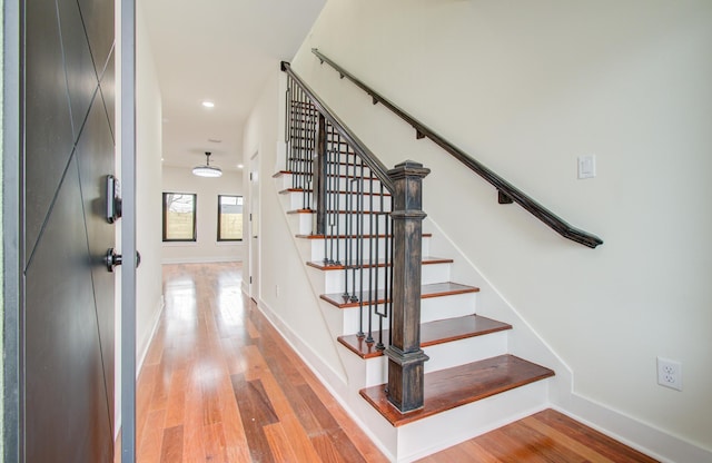 stairway with hardwood / wood-style floors