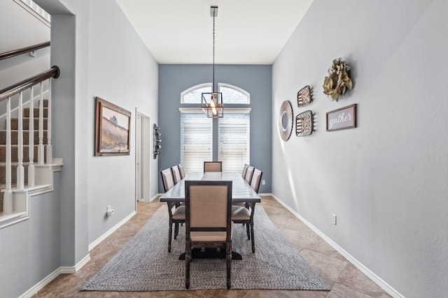 tiled dining space with a chandelier