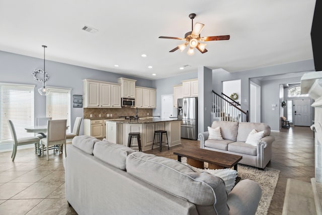 living room featuring ceiling fan and light tile patterned flooring