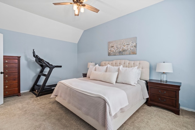 bedroom with ceiling fan, light colored carpet, and vaulted ceiling