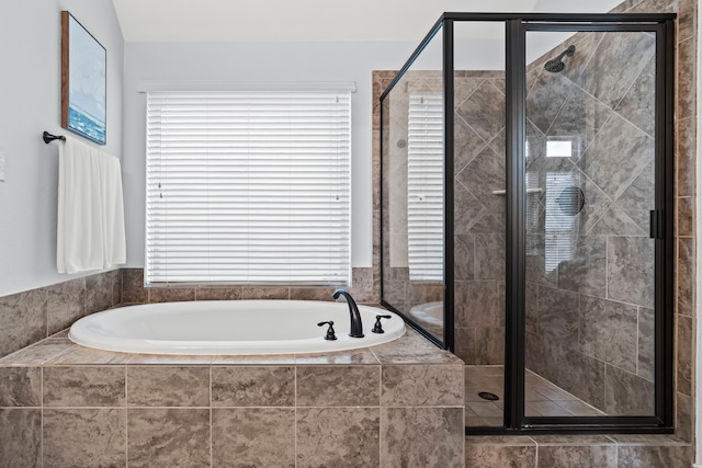 bathroom featuring separate shower and tub