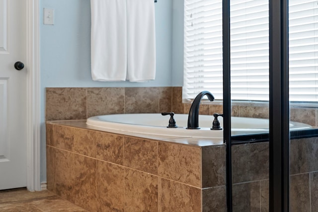 bathroom featuring a relaxing tiled tub