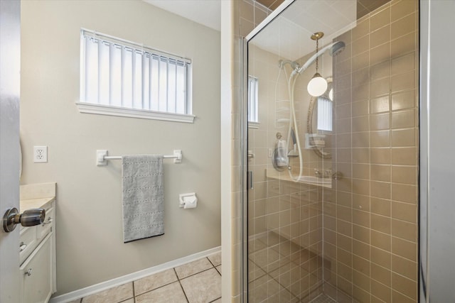 bathroom with vanity, a shower with door, and tile patterned floors