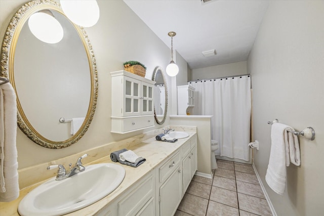 bathroom with tile patterned flooring, vanity, and toilet