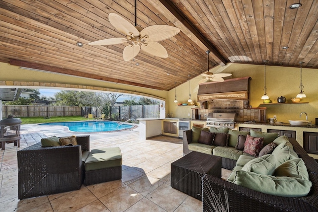 view of swimming pool featuring exterior kitchen, a grill, sink, and ceiling fan