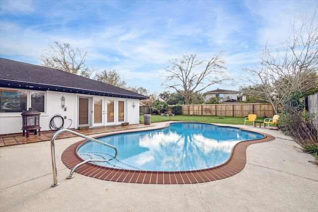 view of swimming pool featuring a patio and french doors