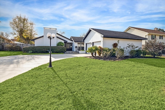 exterior space with a garage and a lawn