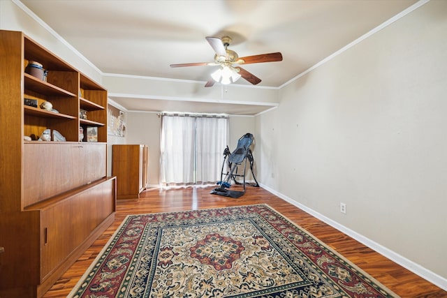 interior space featuring hardwood / wood-style flooring, crown molding, and ceiling fan