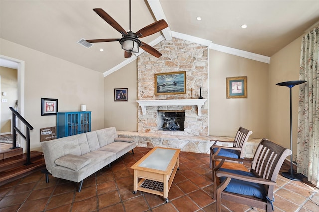 living room featuring ceiling fan, a stone fireplace, and lofted ceiling with beams