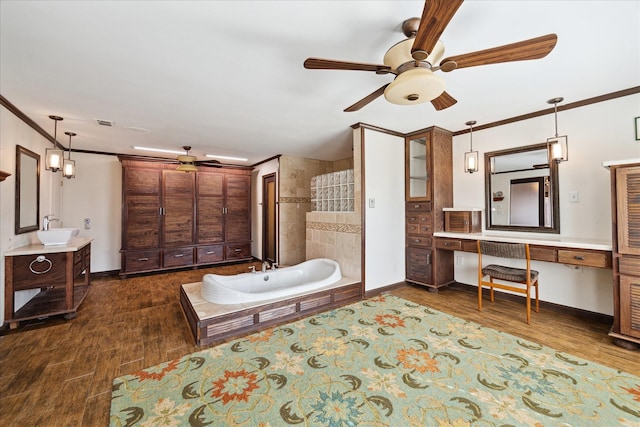 bathroom featuring hardwood / wood-style flooring, ceiling fan, vanity, ornamental molding, and a tub to relax in