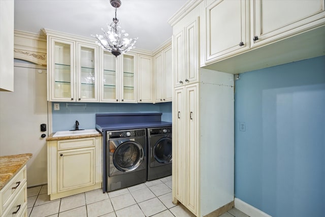 laundry area with separate washer and dryer, sink, cabinets, light tile patterned floors, and a notable chandelier