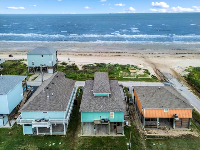 drone / aerial view with a water view and a beach view