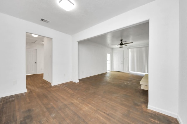 empty room with dark wood-type flooring and ceiling fan