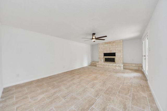 unfurnished living room featuring ceiling fan and a fireplace