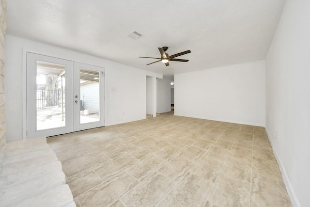 empty room with french doors and ceiling fan