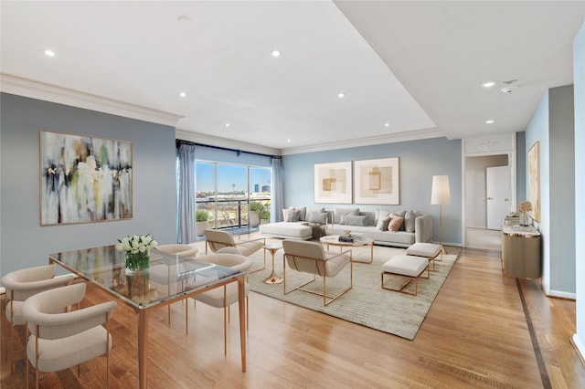 living room featuring ornamental molding and light wood-type flooring