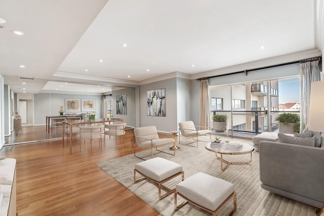 living room featuring ornamental molding and light hardwood / wood-style floors