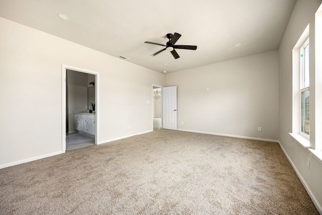 unfurnished bedroom with carpet floors, ceiling fan, and ensuite bathroom