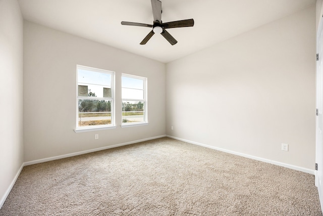 carpeted spare room with ceiling fan