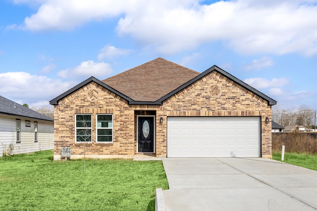 view of front of property with a garage and a front lawn