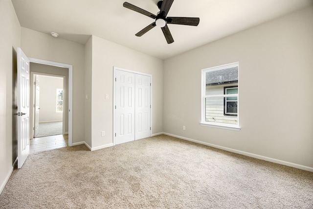 unfurnished bedroom featuring ceiling fan, carpet floors, and a closet