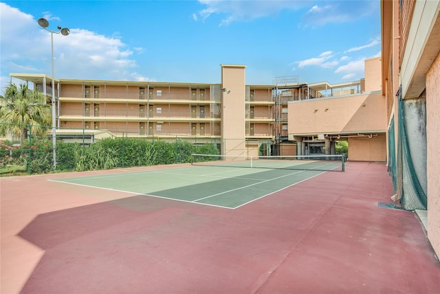 view of tennis court featuring basketball hoop