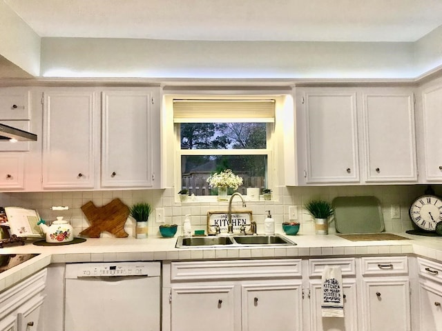 kitchen with white cabinetry, sink, decorative backsplash, and dishwasher