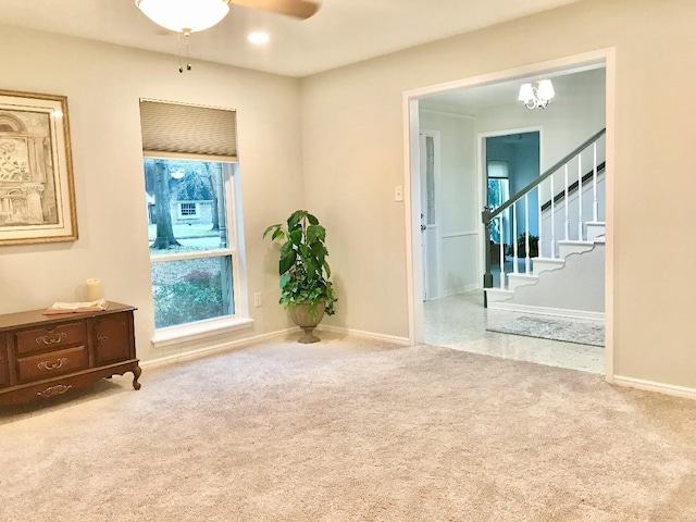 spare room with ceiling fan and carpet flooring