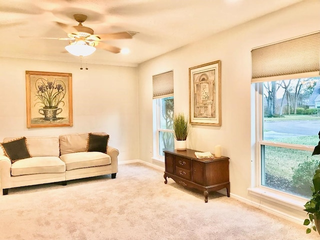 carpeted living room with ceiling fan